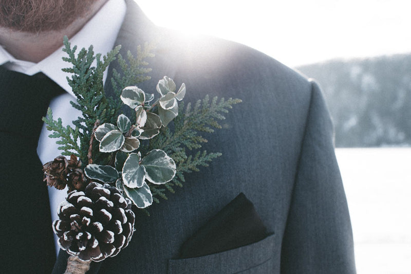 Groom wearing a winter flower button hole for a December wedding