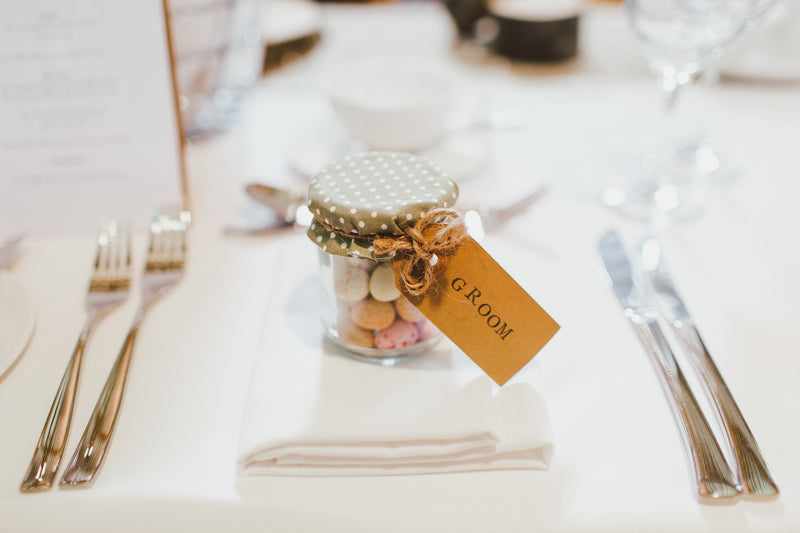 a tub of mini eggs as a guest place at a wedding