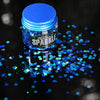 pot of blue face glitter sprinkled on a surface