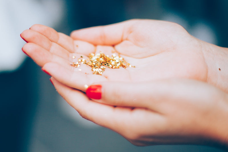 Woman with a handful of glitter to emphasise ban on single use plastic 