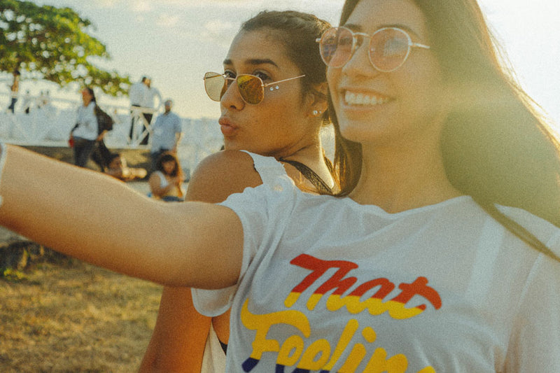 two girls at a festival demonstrating tips for taking a selfie 