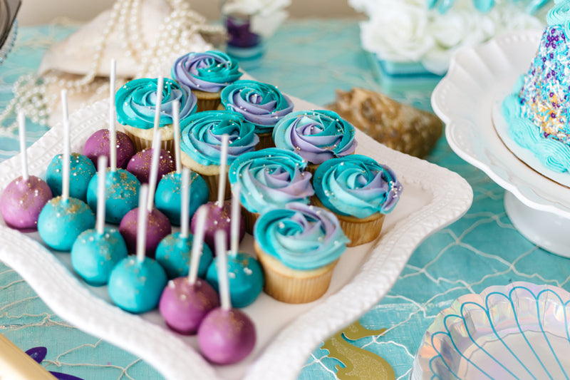 blue and purple multi coloured cakes on a pretty plate for small baby shower ideas