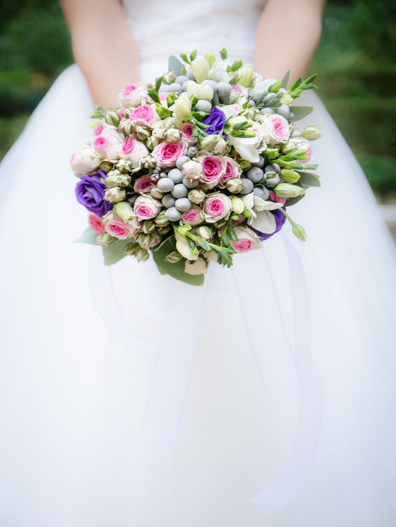 Planning Your Makeup For A Summer Wedding - Bride holding a colourful bridal bouquet. 
