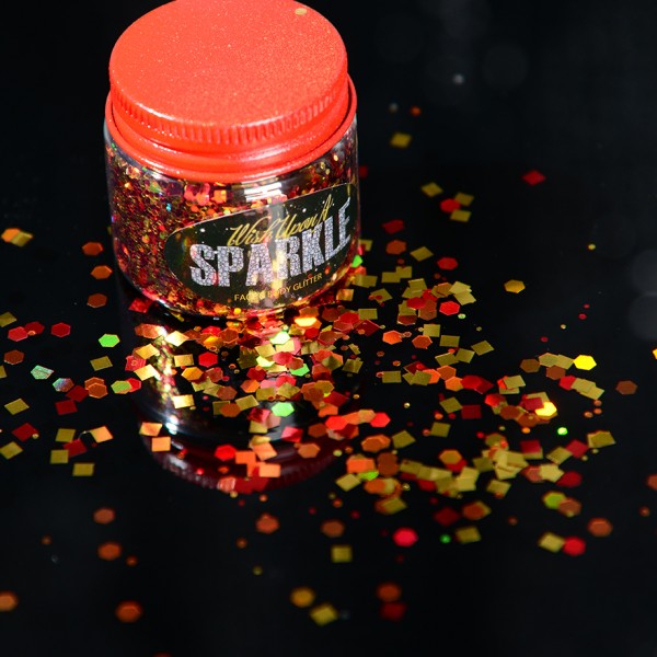 pot of orange and yellow face glitter