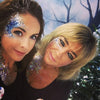 two women wearing blue glitter on their faces