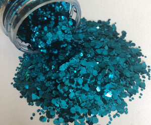 Ocean blue biodegradable glitter pouring out of pot
