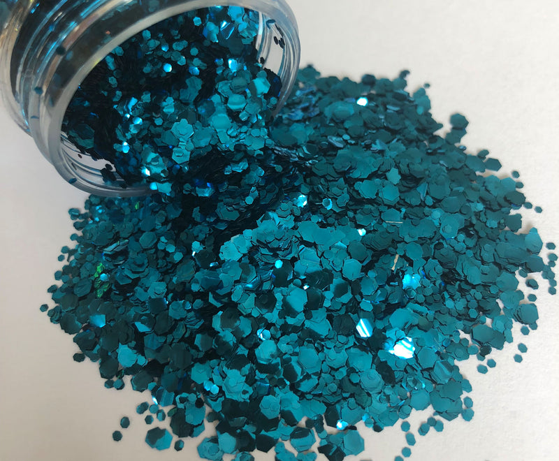 Ocean blue biodegradable glitter pouring out of pot