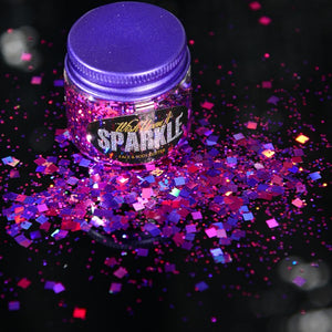 tub of purple face glitter that is sprinkled on the side 